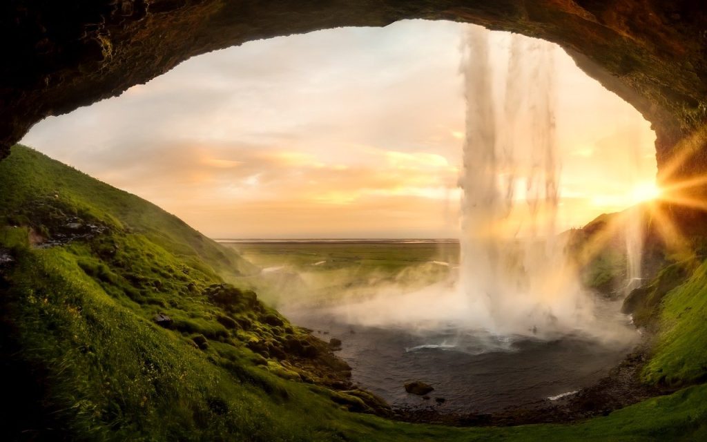 Waterfall in Iceland with sun at its peak