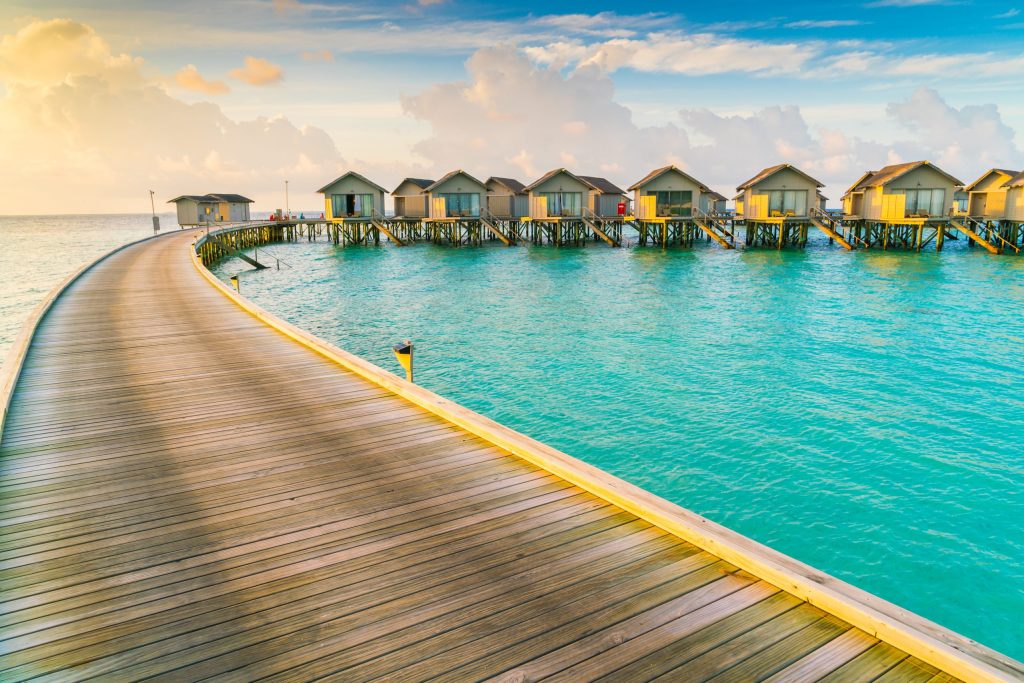 Beautiful water villas in tropical Maldives island at the sunrise time