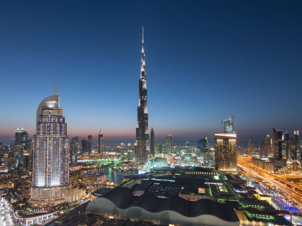 Burj Khalifa , the Dubai Mall and skyline of Downtown Dubai at night in United Arab Emirates.