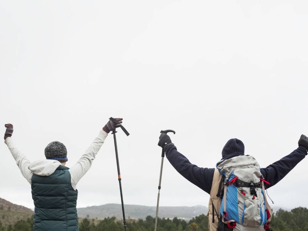 Fit couple rejoicing after trek.