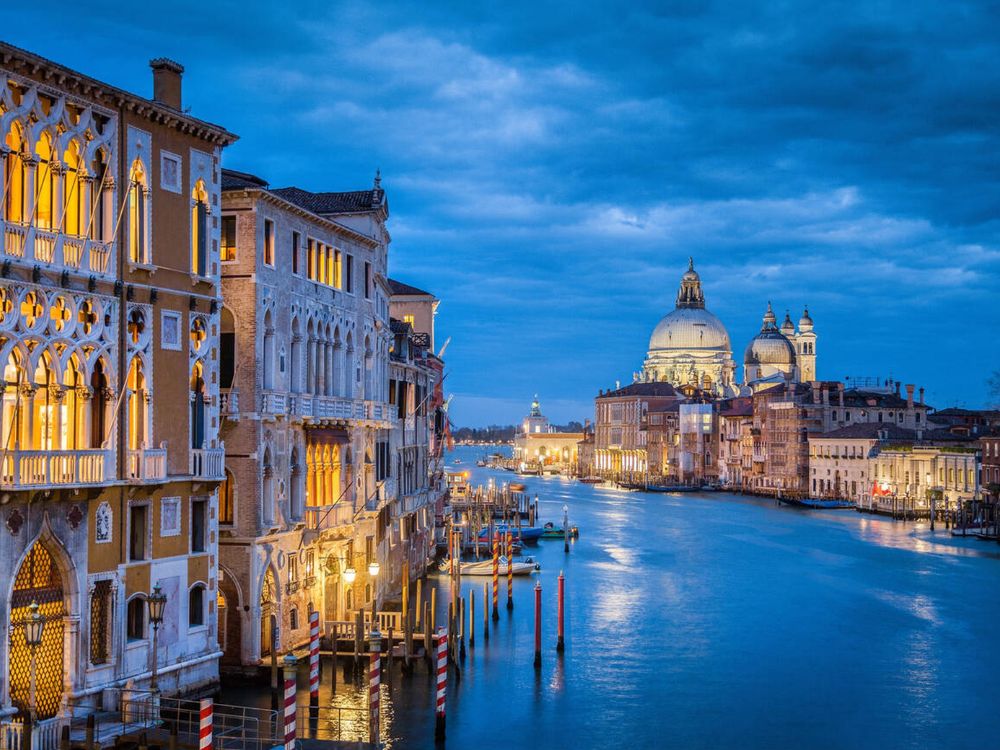 Classic view of famous Canal Grande with historic Basilica di Santa Maria della Salute in the background in twilight, Venice, Italy