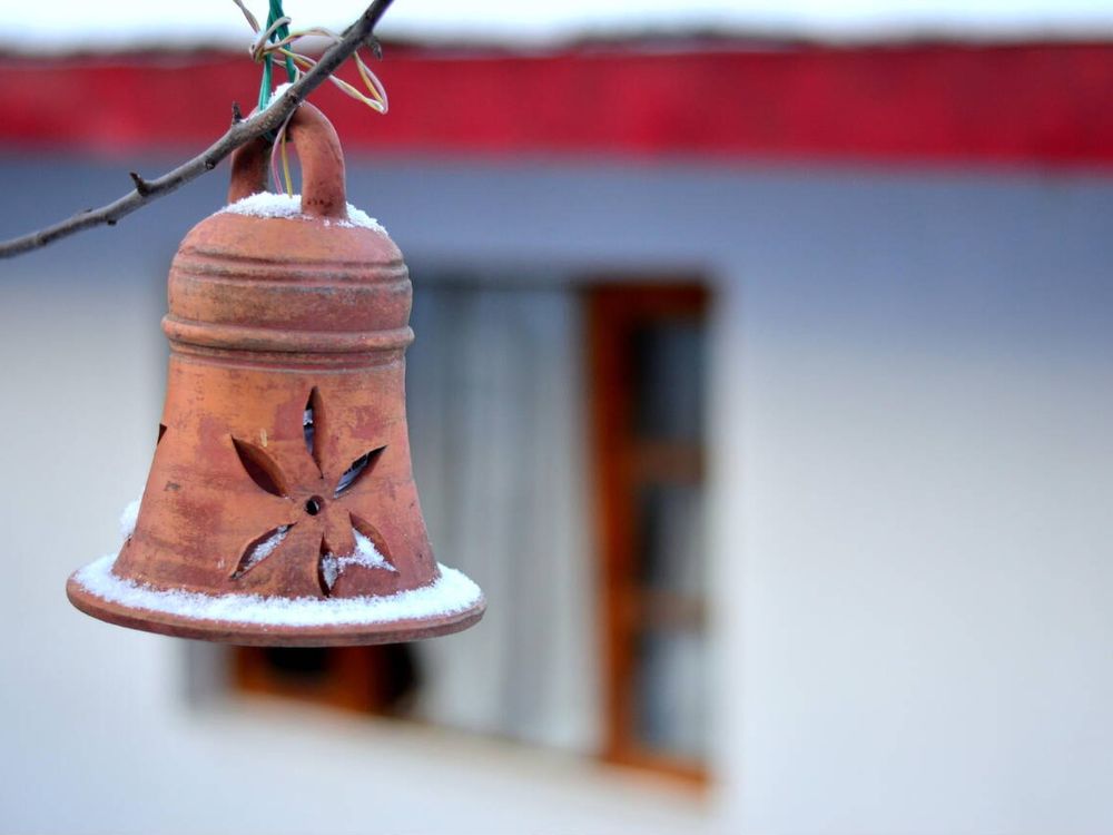 Clay lamp hanging from a rope covered in snow after fresh snowfall in Kufri, Shimla, Himachal Pradesh.
