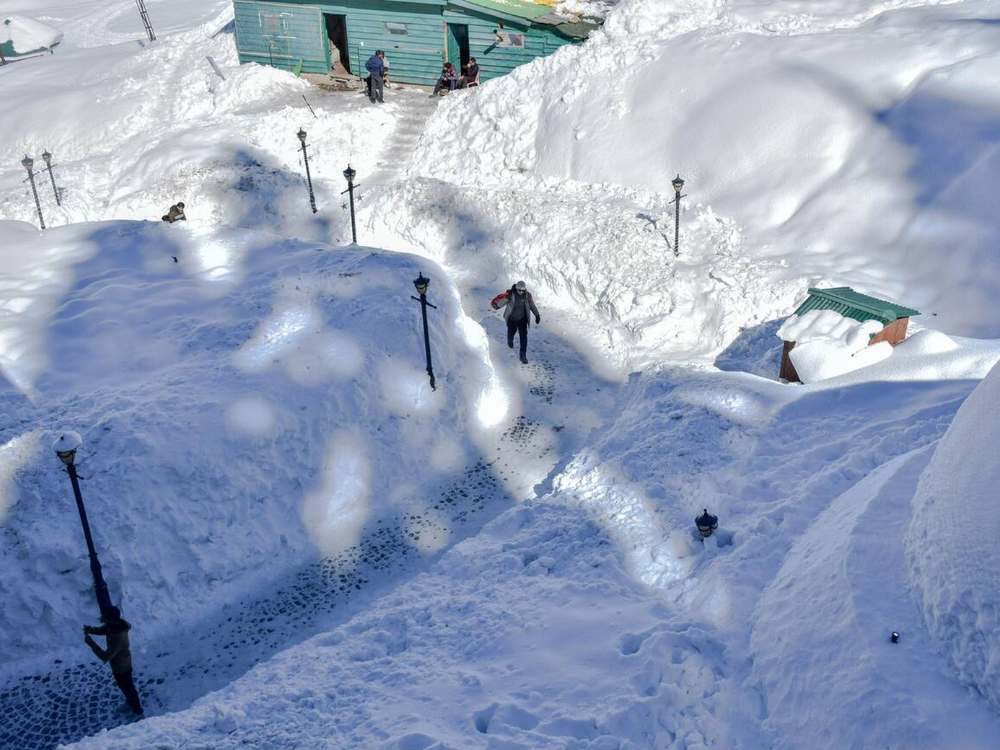 Indian tourists enjoy the ride on snow sledges during a winter day