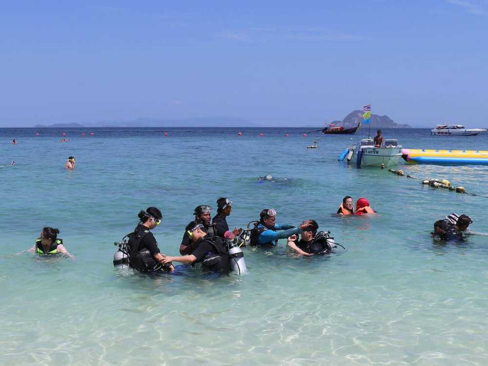 Tourists learning how to snorkel with gears