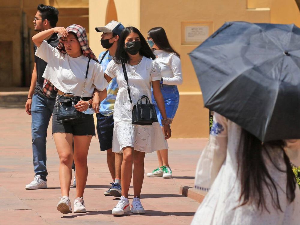 Tourists visit historical Jantar Mantar during a hot summer day