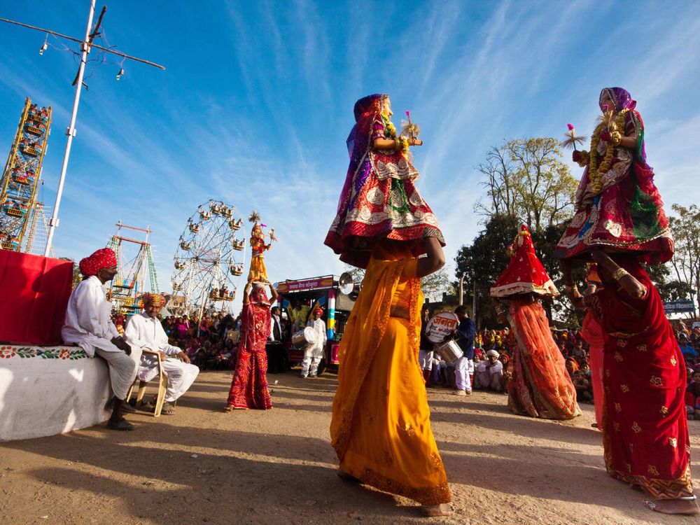Womens dancing with Idols on their head at Gangaur festival