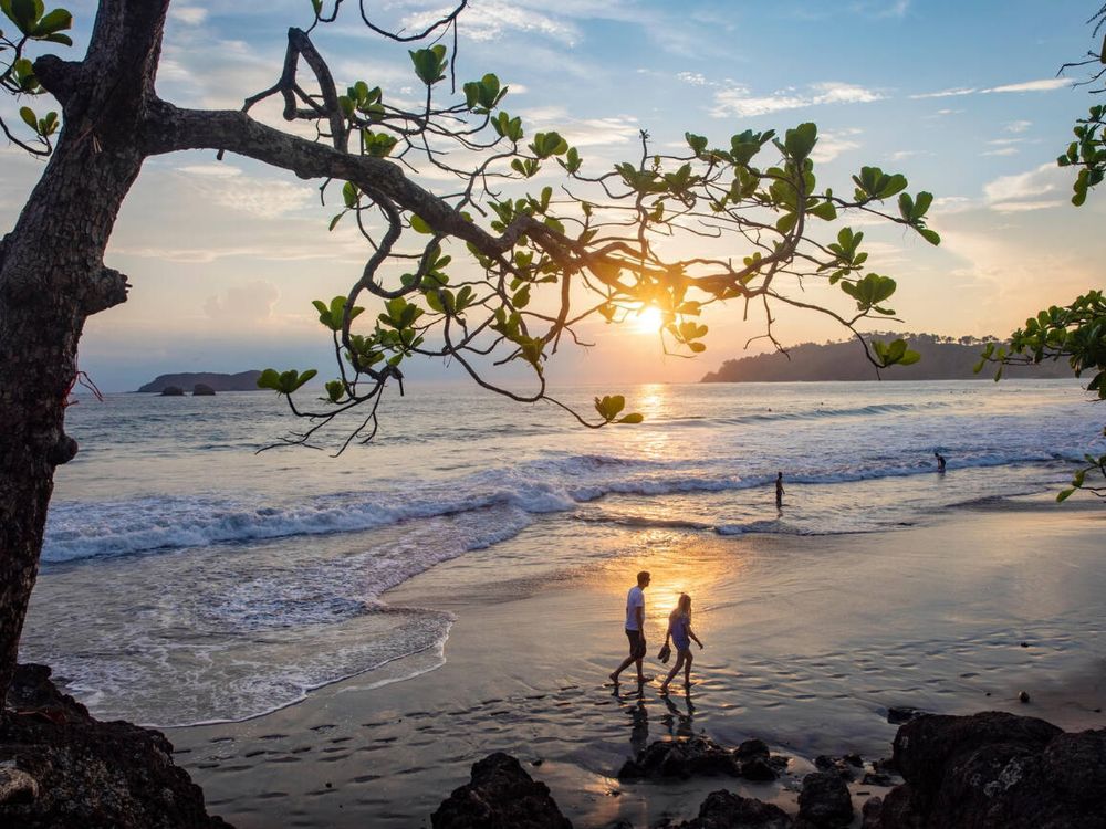 Couple walking in the sunset on Espadilla Norte Beach, Manuel Antonio, Quepos, Costa Rica