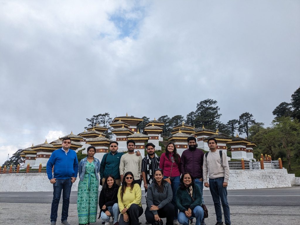People in group posing in front of Dochula pass in Bhutan