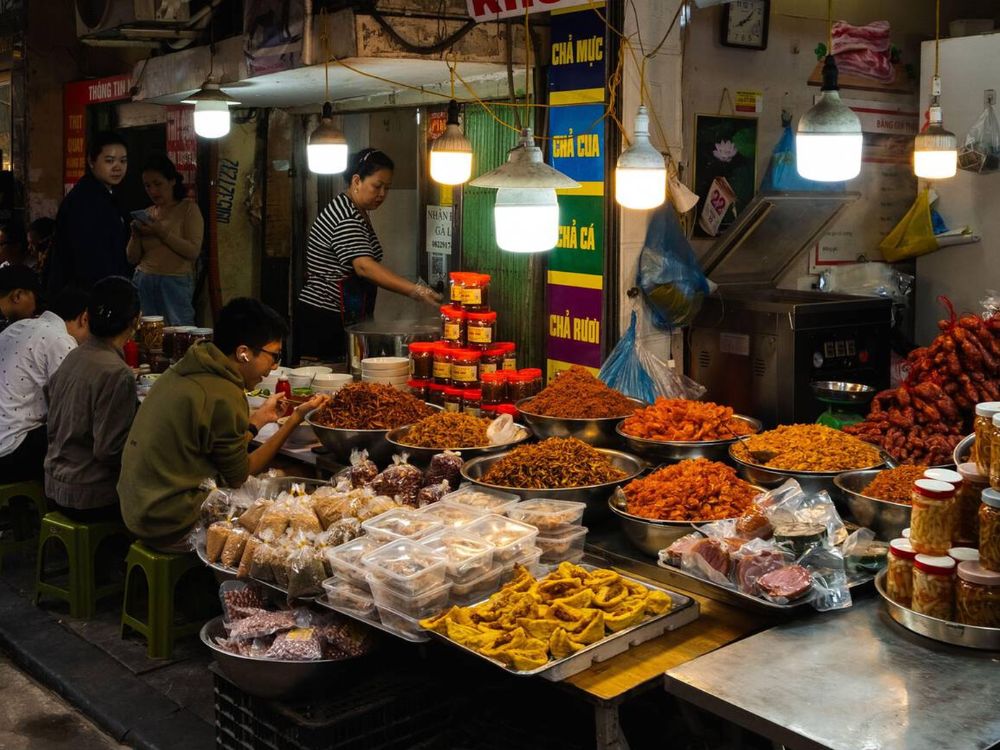 A Vietnamese street food market filled with vendors and customers